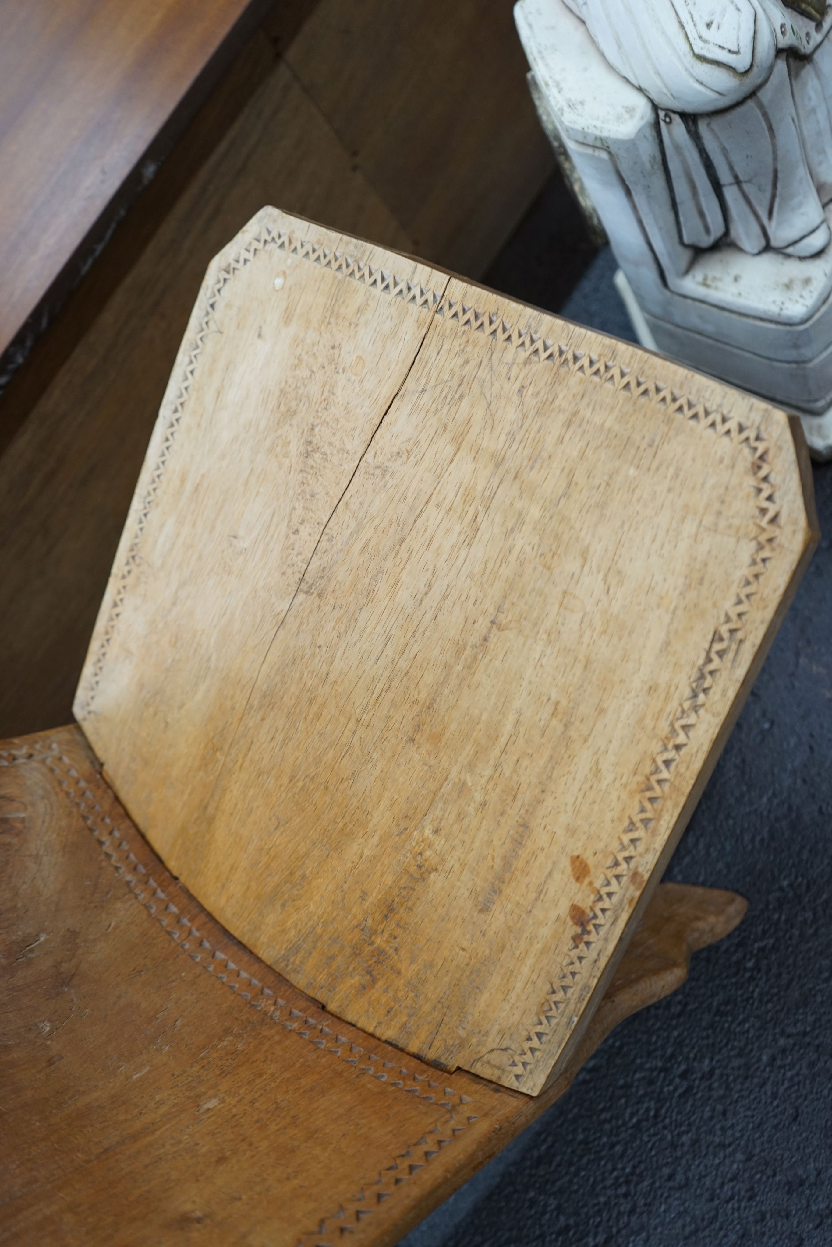 An African chip carved hardwood seat, height 90cm